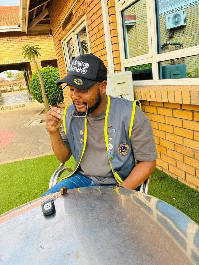 A Lions Club member wearing his service vest and pins